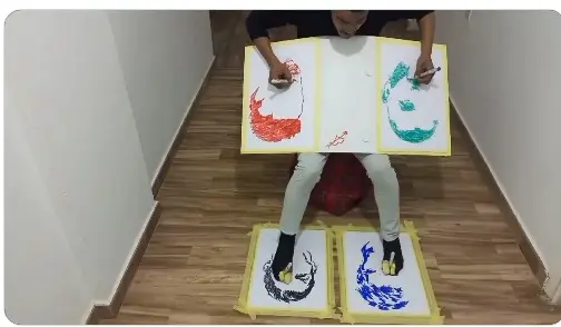 ليبي يستخدم يديه وقدميه لرسم 4 لوحات مختلفة في آن واحد (فيديو)