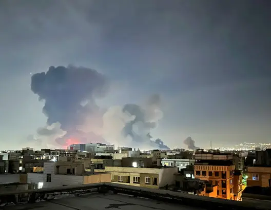 مدينة ليلية تغطيها سحب كثيفة ودخان أسود تعبيراً عن تداعيات اقتصادية